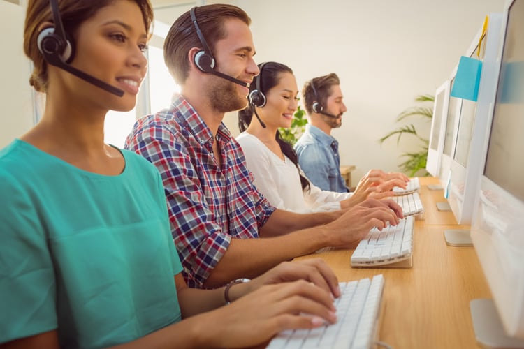 HubSpot vs. Pardot | Customer Service | Representatives at call center wearing headsets