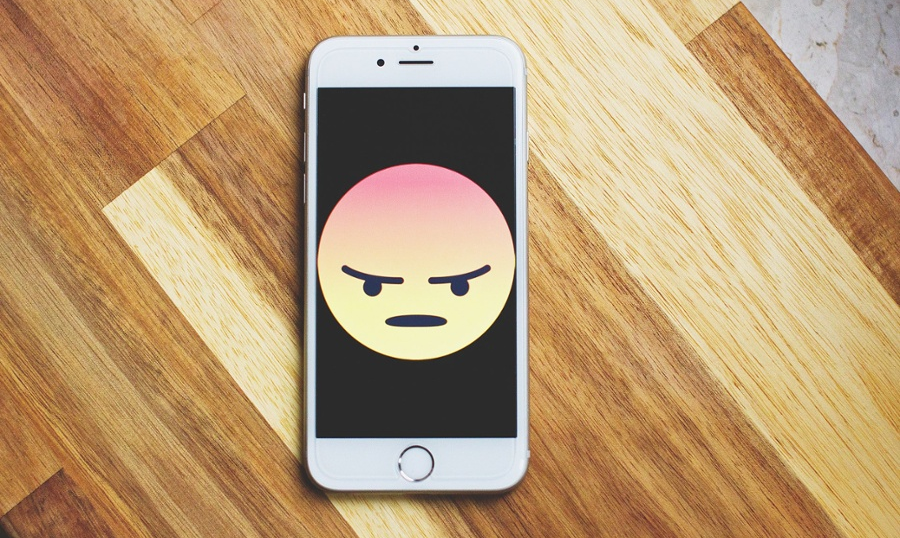 Bad reviews - angry Facebook emoji on phone