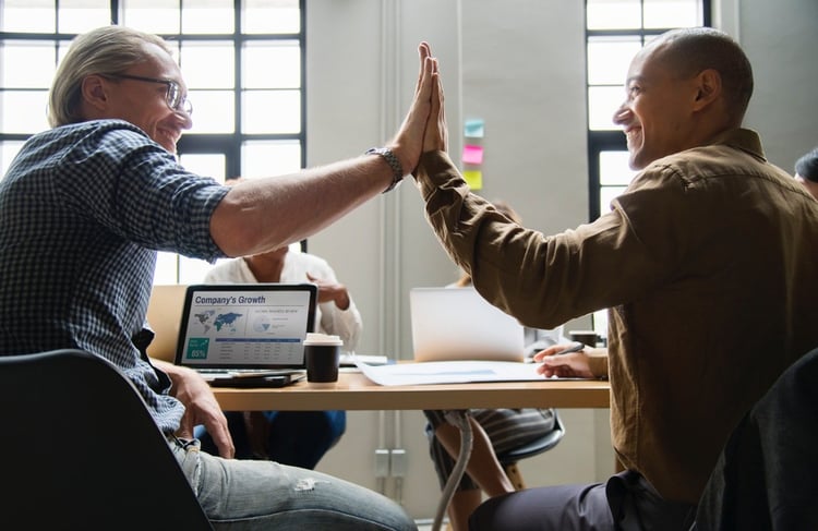 website refresh to generate more leads - coworkers celebrating